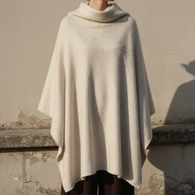 Cream Poncho Draped by Wall in Golden Sunlight - Fashion - AI generated image