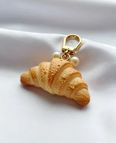 Golden Croissant Bag Charm with Pearls - Fashion - AI generated image