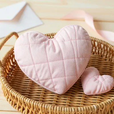 Quilted Heart Pouch Resting in Basket - Furniture - AI generated image