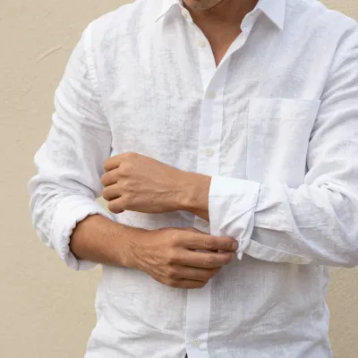 Man Adjusting Cuffs of White Linen Shirt - People - AI generated image