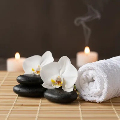 Orchid Serenity with Black Stones and Lit Candles - Spa - AI generated image