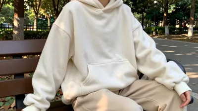 Person in Cream Hoodie Relaxing on Park Bench - People - AI generated image