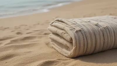 Folded Beach Towel on Sandy Shore - Beach - AI generated image
