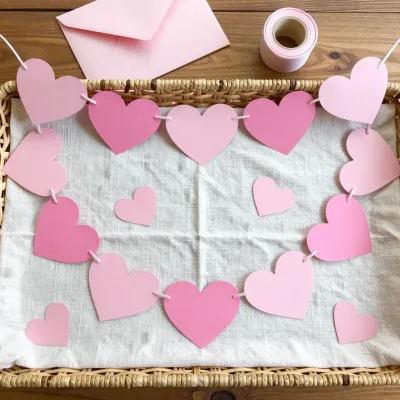 Paper Heart Garland Hanging on Woven Basket - Decor - AI generated image