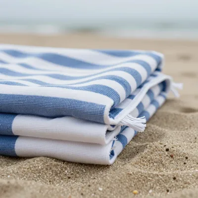 Folded Beach Towels Softly Lit on Sandy Beach - Beach - AI generated image