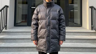 Person in Puffer Coat on Stone Steps - Fashion - AI generated image