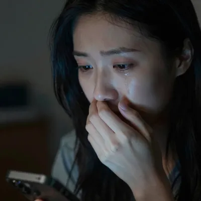 Anxious Woman Holding Smartphone in Low Light - Portrait - AI generated image