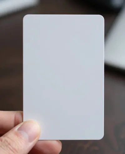 White Credit Card Held Between Fingers - Objects - AI generated image