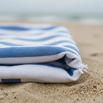 Folded Beach Towel Softly Lit on Sandy Beach - Beach - AI generated image