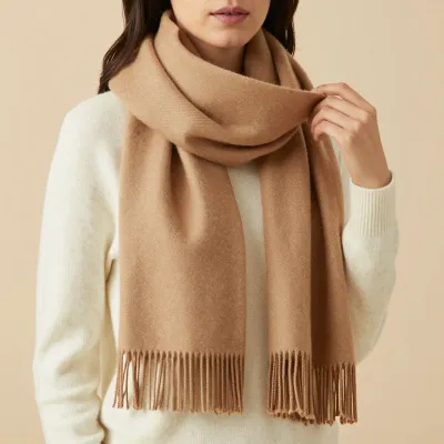 Woman Displaying Camel-Knit Scarf with Fringes - Fashion - AI generated image