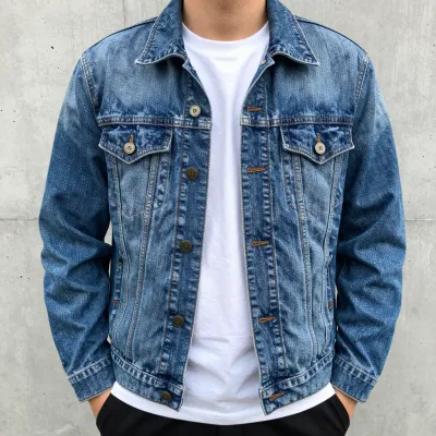 Worn Denim Jacket on Street Wall - Fashion - AI generated image