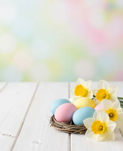 Pastel Eggs in Woven Basket with Daffodils - Easter - AI generated image