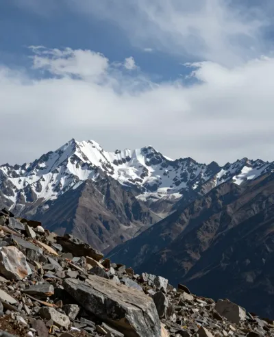 Rocky Foreground Leading to Snow-Capped Peaks at Sunset - Landscape - AI generated image