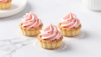 Mini Tarts with Pink Frosting on Marble - Food - AI generated image