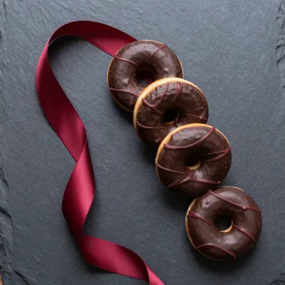 Chocolate Glazed Donuts with Burgundy Ribbon - Food - AI generated image