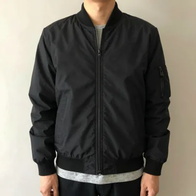 Person in Black Bomber Jacket with Soft Lighting - Fashion - AI generated image