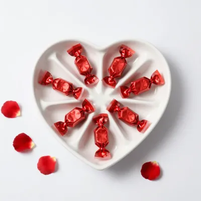 Heart-Shaped Tray with Red Candies and Rose Petals - Food - AI generated image