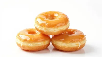Stack of Orange-Glazed Donuts with Glossy Finish - Food - AI generated image