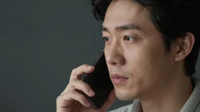 Man Engaged in Phone Call with Soft Lighting - Portrait - AI generated image