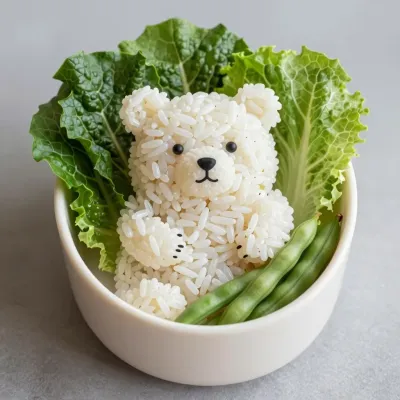 Bear-Shaped Rice Ball on Greens - Food - AI generated image
