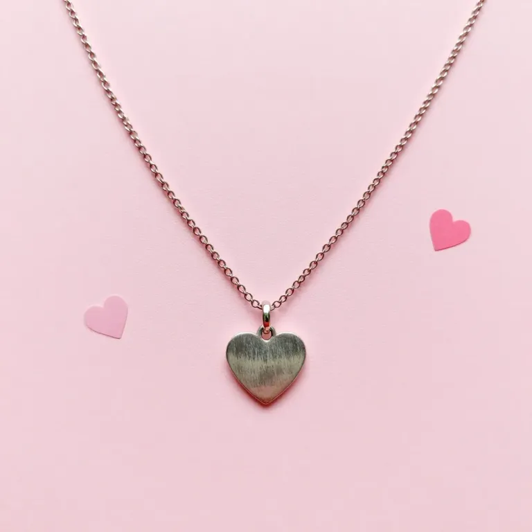 Heart Pendant with Thin Chain on Pink Background - Jewelry - AI generated image
