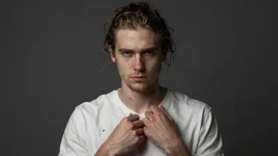 Young Man with Wet Hair Clasping Stained T-Shirt - People - AI generated image