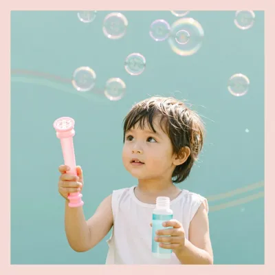 Child Blowing Bubbles with Pink Wand - Child - AI generated image