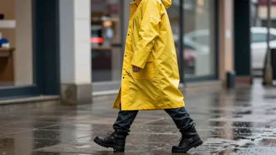 Person in Yellow Hooded Raincoat Walking on Wet Pavement - Fashion - AI generated image