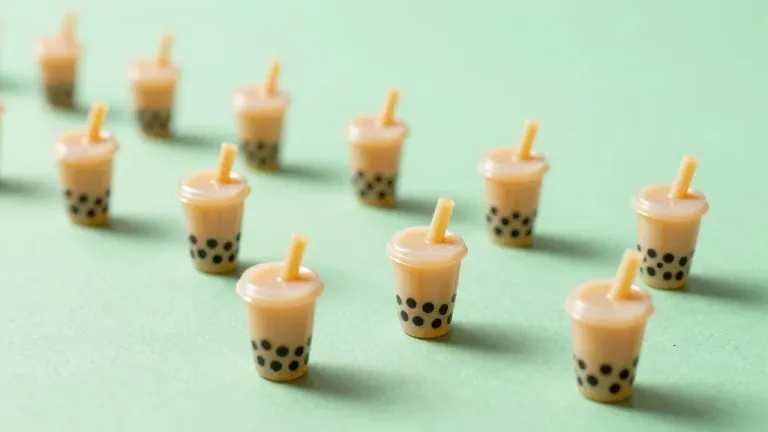 Miniature Bubble Tea Cups Clustered on Mint Green - Food - AI generated image