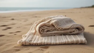 Folded Beach Towel on Sandy Shore - Beach - AI generated image