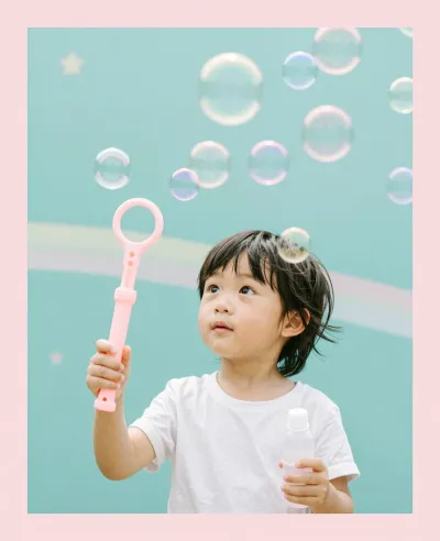 Child Blowing Bubbles with Pink Wand - Children - AI generated image