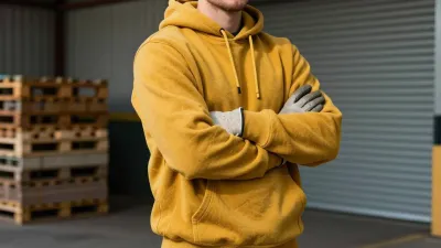 Man in Yellow Hoodie Arms Crossed Warehouse - People - AI generated image