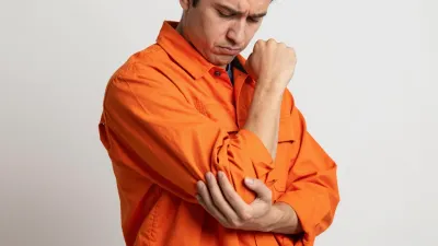 Construction Worker Clutching Elbow in Pain - People - AI generated image