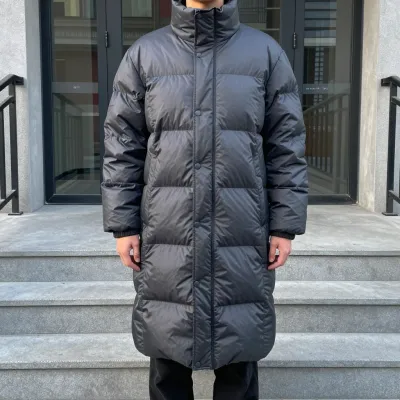 Person in Dark Gray Puffer Coat on Stone Steps - Fashion - AI generated image