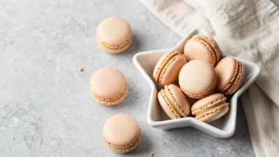 Star-Bowl Filled with Golden Macarons - Food - AI generated image