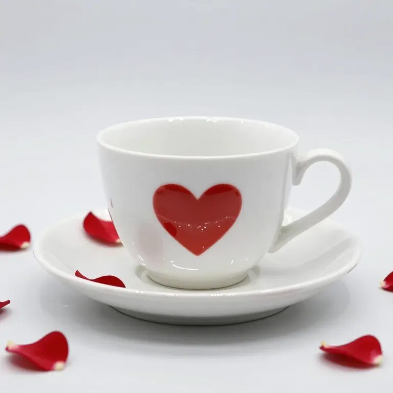White Ceramic Teacup with Red Heart Motif on Saucer - Tableware - AI generated image