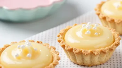 Golden Lemon Curd Tartlets with Silver Beads - Food - AI generated image