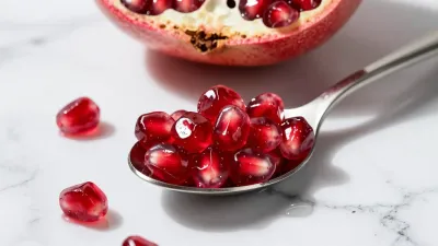 Pomegranate Seeds in Spoon on Marble - Food - AI generated image