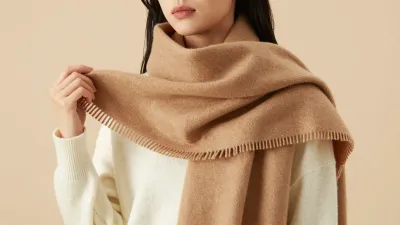 Woman Adjusting Camel Knit Scarf - Fashion - AI generated image