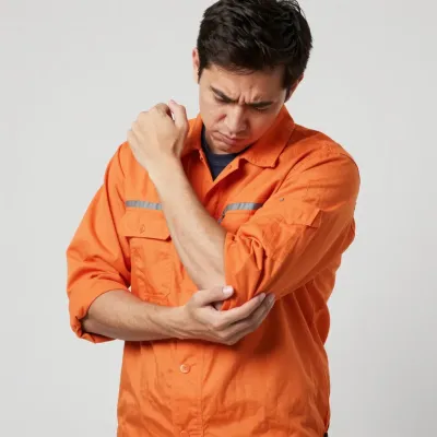 Construction Worker with Elbow Pain in Orange Jumpsuit - People - AI generated image
